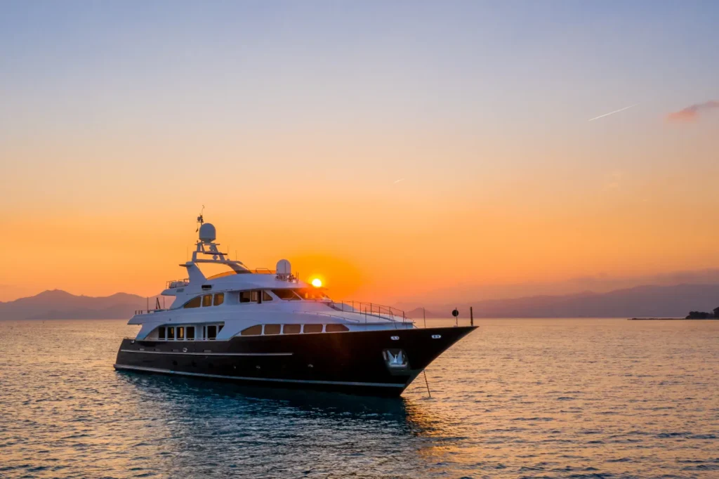 Luxury yacht cruising on the water at sunset