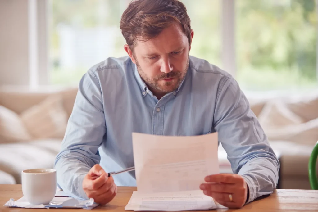 A man reading boat insurance document
